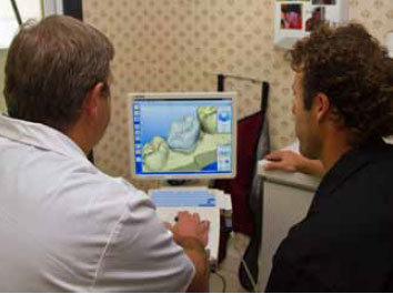Dr. Richard Jakowski and Dr. Greg Johnson of Pleasant Family Dentistry use the latest technology to evaluate patient's teeth.